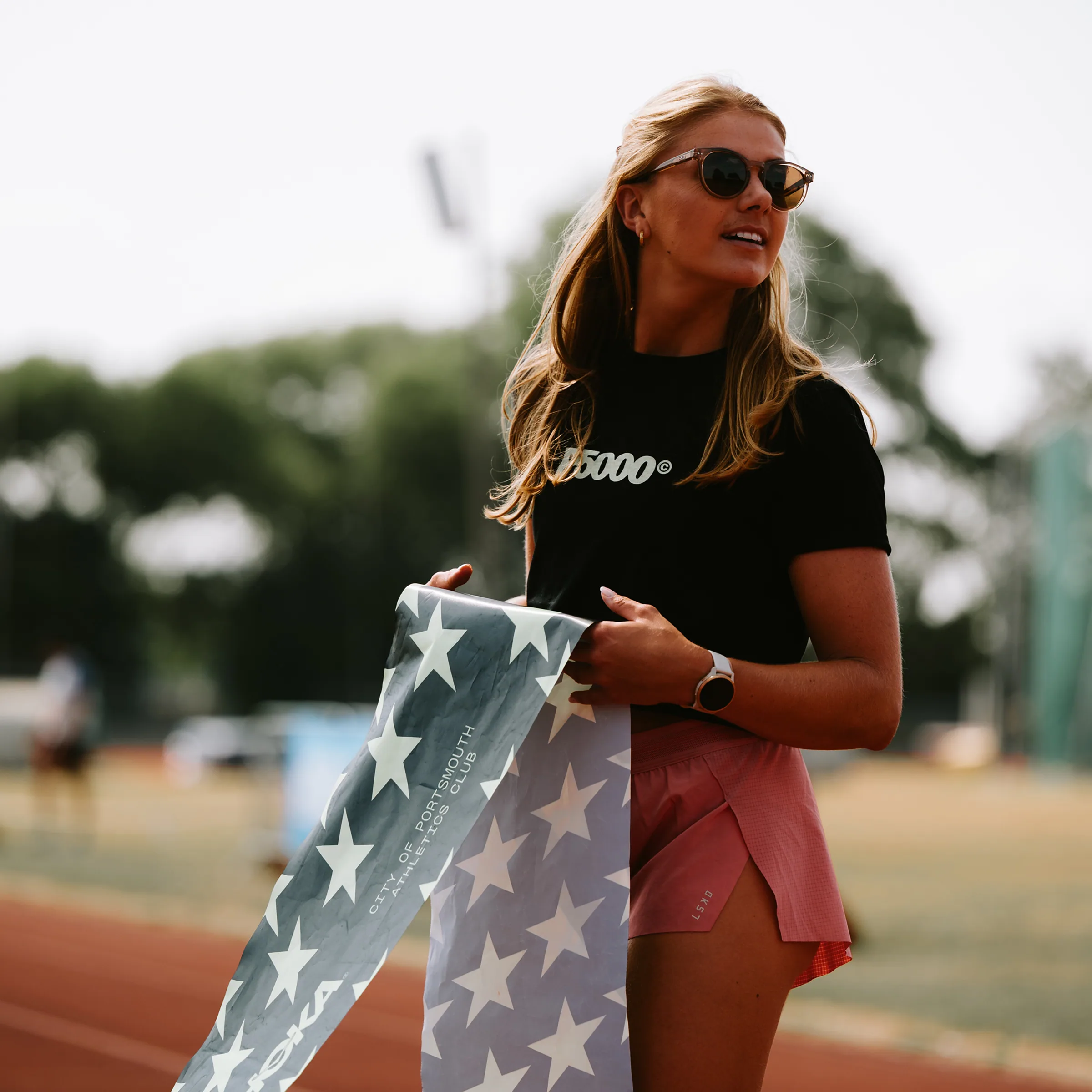 girl holding finish line banner